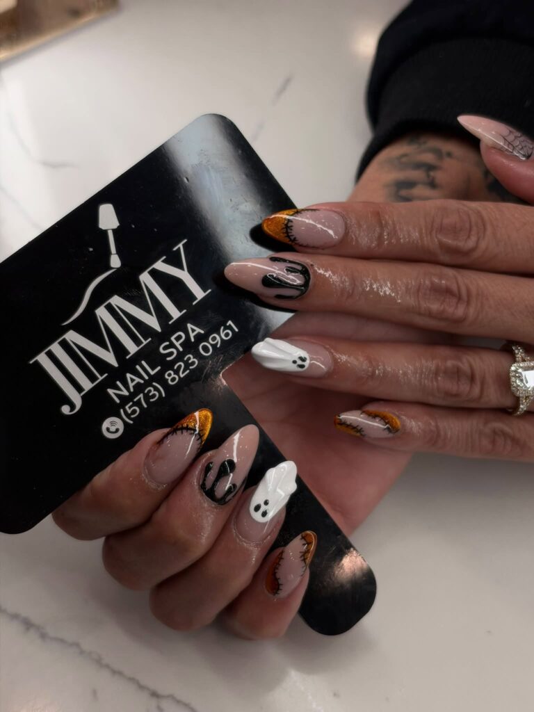Pumpkin, ghost and spiderweb nail art photographed at Jimmy Nails & Spa in Columbia, Missouri.