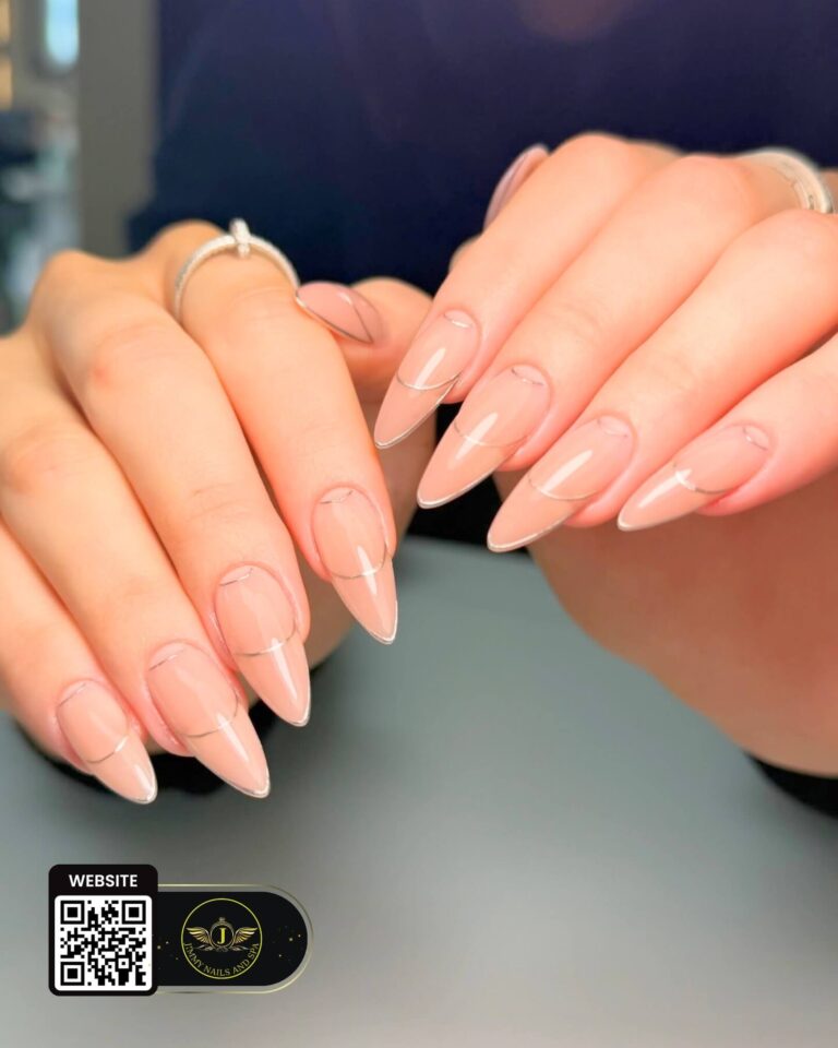Sheer nude almond nails with delicate white French tips by Jimmy Nails & Spa.