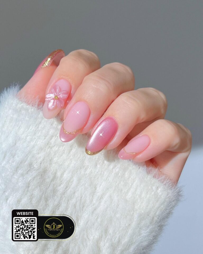 Pink nail art with a floral accent and gold details by Jimmy Nails & Spa.