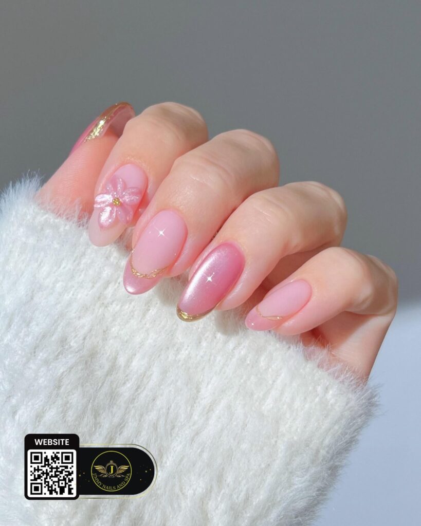 Pink nail art with a floral accent and gold details by Jimmy Nails & Spa.