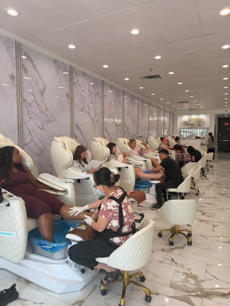 Guests receiving pedicures in the cream massage chairs at Jimmy Nails & Spa in Columbia.
